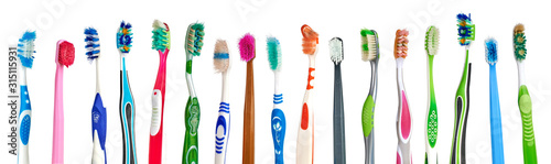 Old, used and dirty colorful toothbrushes on white background