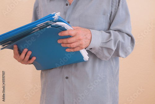 Person is holding folders which are going to be organized for business or personal use.