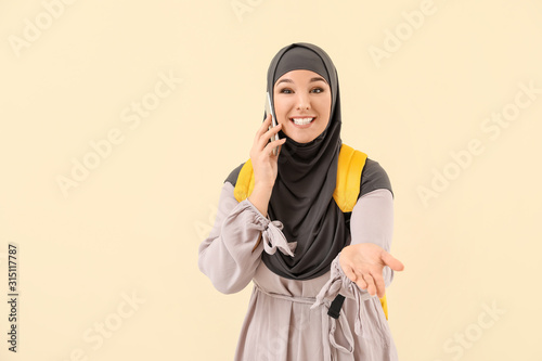Female Muslim student talki...