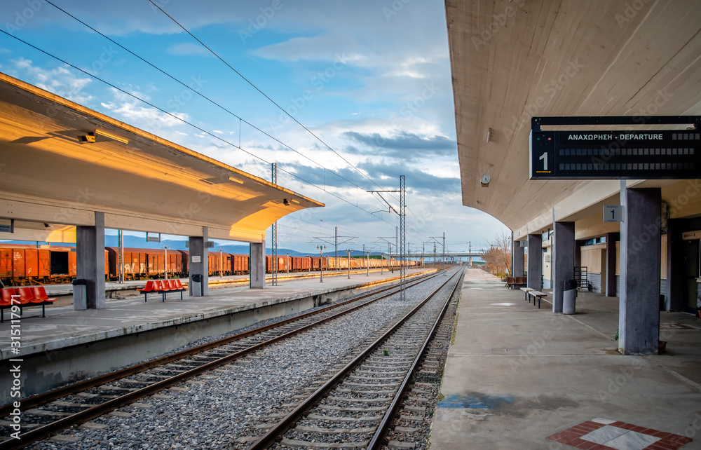 View of the railway station in Leianokladi. The station is situated near Lamia, in central Greece (sign says View of the railway station in Leianokladi. The station is situated near Lamia, in central Greece (sign says