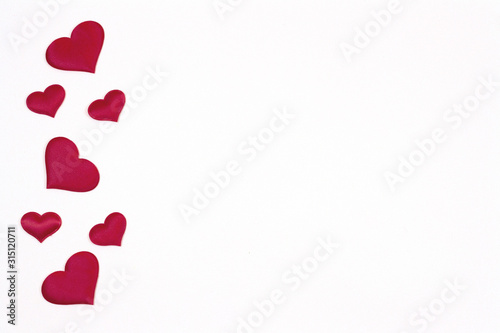 Valentine's day background. Red hearts on a white background. Valentine's day concept. Flat lounger, top view, copy space.