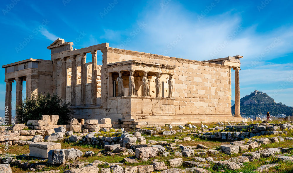 The Erechtheion (or Erechtheum), an ancient Greek temple on the north side of the Acropolis of Athens in Greece, dedicated to Athena and Poseidon. Mount Lycabettus is on the right.