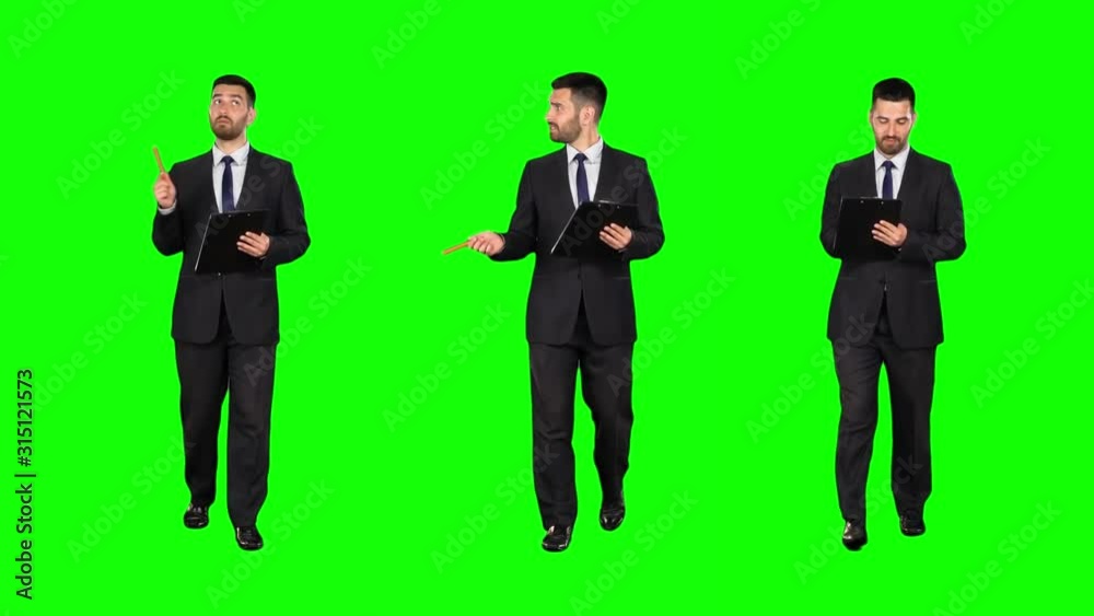 Businessman with a tablet walks on Green screen. Three takes. Slow motion. Businessman with a tablet walks on Green screen. Three takes. Slow motion.