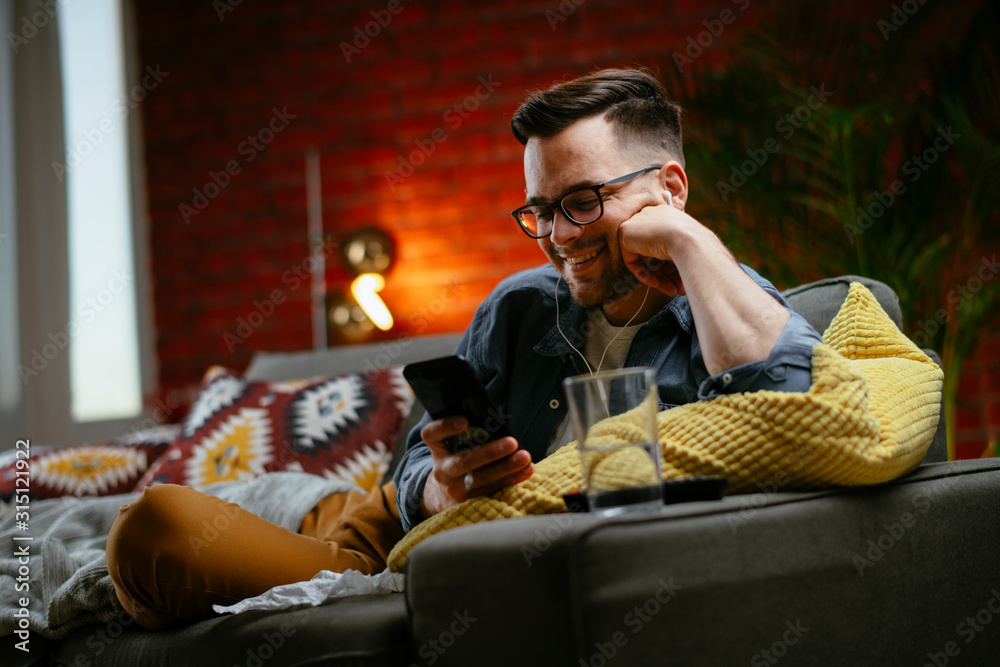Obraz premium Young man having a video call. Handsome man talking on his smartphone.