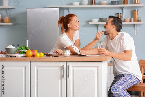 Happy couple in kitchen at ...