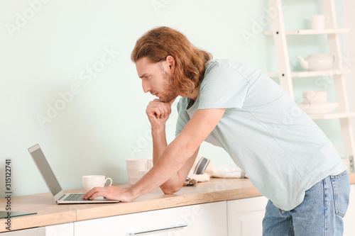 Handsome man with laptop in...