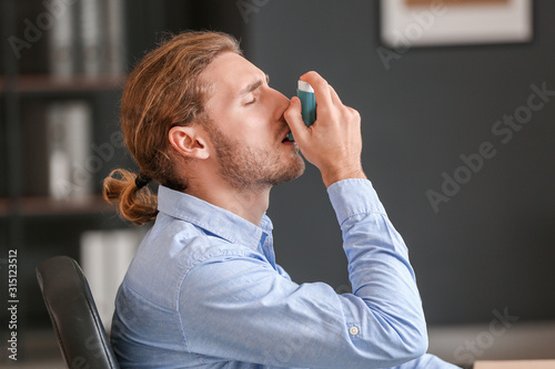 Sick businessman with inhal...