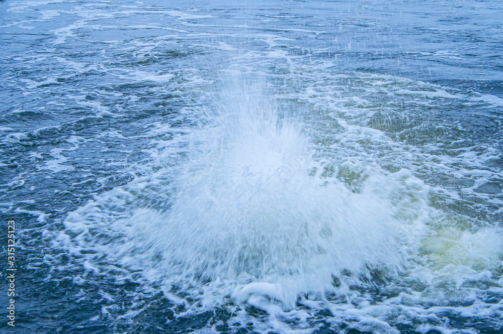 Water boils near the shore in winter. Storm fountain Water boils near the shore in winter. Storm fountain