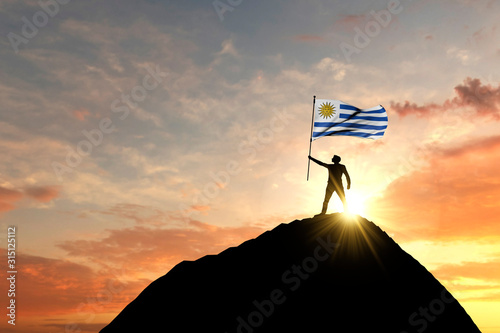 Uruguay flag being waved at the top of a mountain summit. 3D Rendering