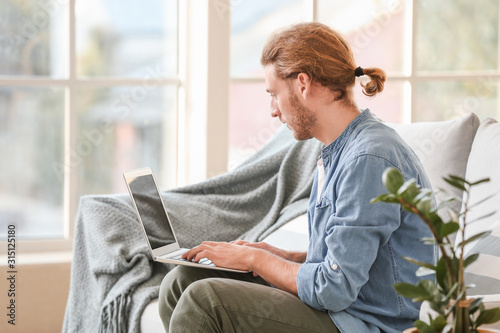 Handsome man with laptop on...