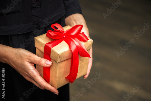 Close up view of old woman holding a gift box photo