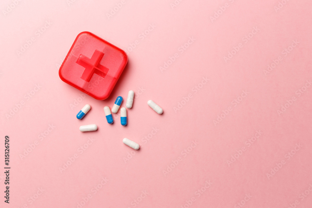 Dose pill box with medical pills on pink background. Top view. Flat lay. Copy space. Pharmaceutical medicine pills, tablets and capsules. Medicine concepts. Trendy pastel color Dose pill box with medical pills on pink background. Top view. Flat lay. Copy space. Pharmaceutical medicine pills, tablets and capsules. Medicine concepts. Trendy pastel color
