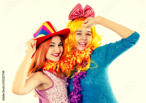 Attractive playful young women ready for carnival parties. Lifestyle and the concept of friendship: a group of two girl friends.