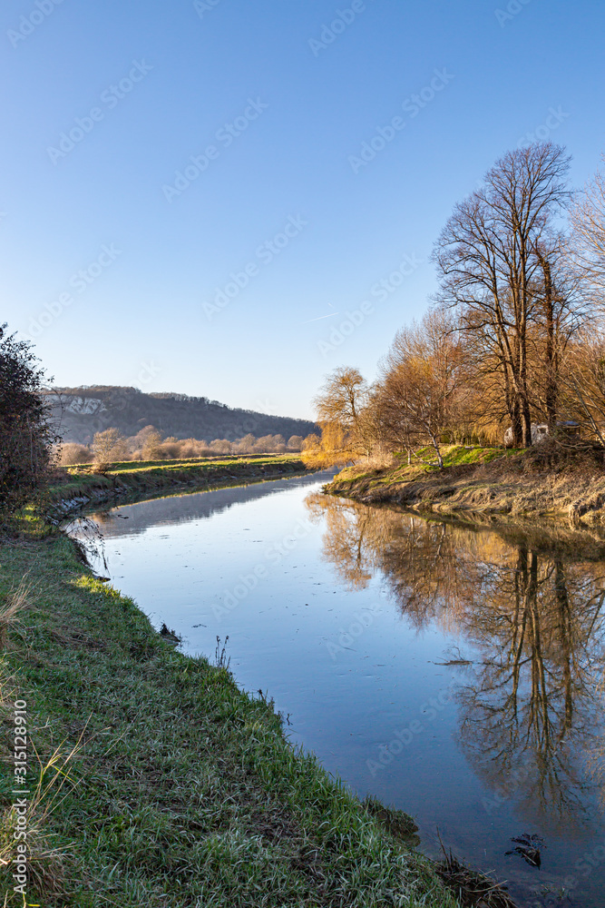 Looking along the River Ouse near Lewes in Sussex, on a sunny winters day Looking along the River Ouse near Lewes in Sussex, on a sunny winters day
