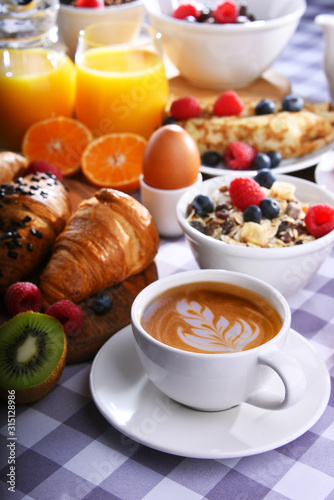 Breakfast served with coffee  juice  croissants and fruits