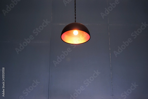 Vintage ceiling lamp and blurred gray wall dark background 