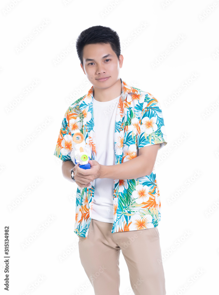 Smiling Asian Thai man holding plastic water gun at Songkran festival, Thailand. Modern fashion men short hair wear Cloth flowers color happy in Thai ceremony Isolated on white background Smiling Asian Thai man holding plastic water gun at Songkran festival, Thailand. Modern fashion men short hair wear Cloth flowers color happy in Thai ceremony Isolated on white background