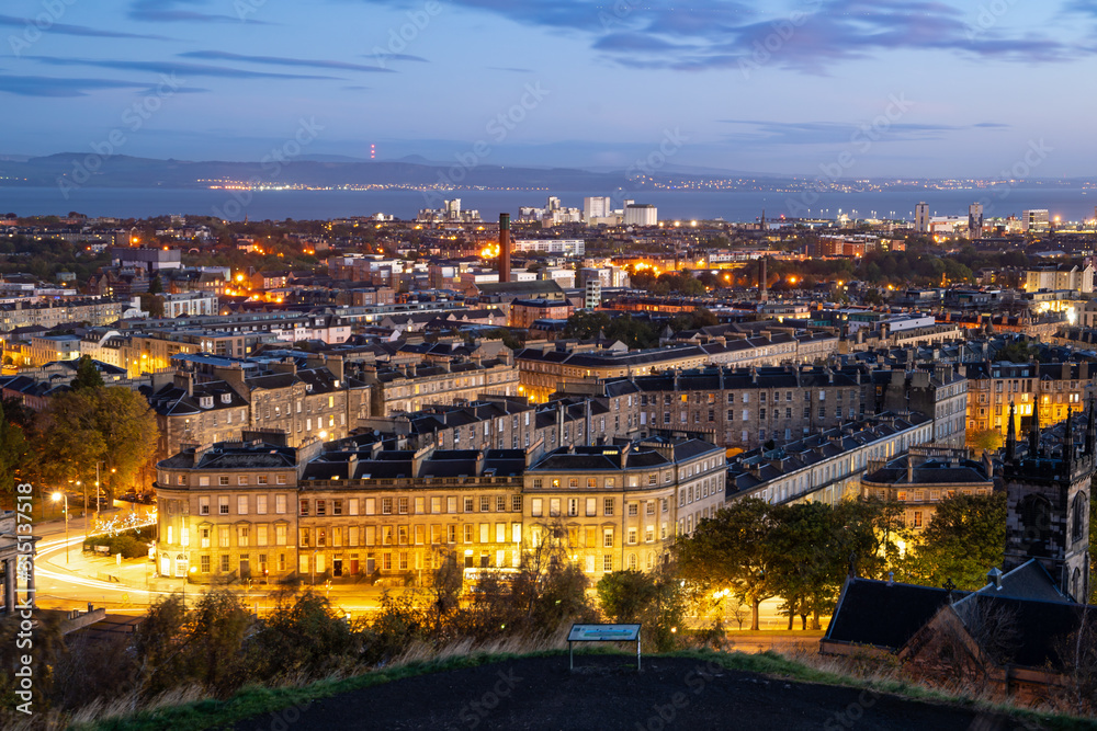 Beautiful landscape of Edinburgh / Scotland panoramic view of Edinburgh from the Calton Hill with the New Old Town on golden light twilight