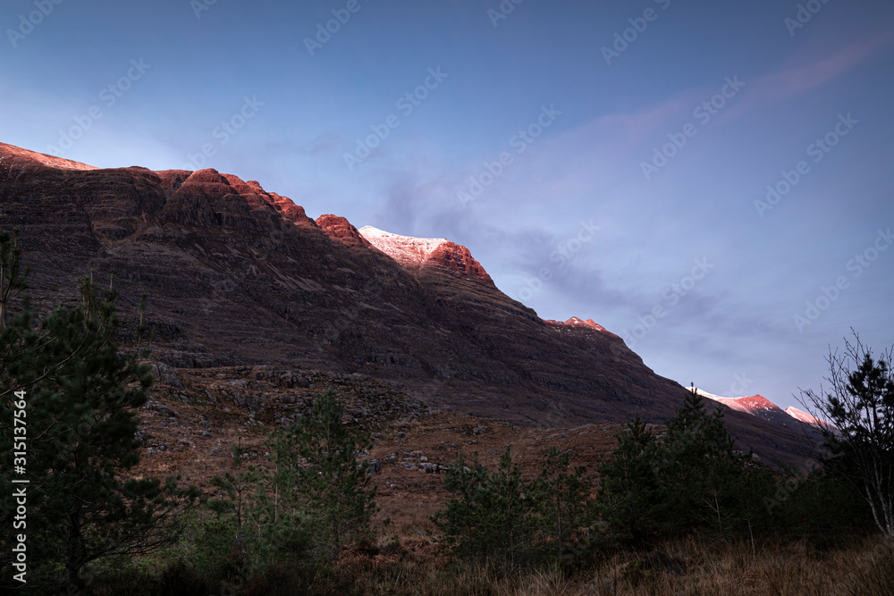 A full frame braketed hdr image of the winter sun setting on the Torridon mountains Liathach and Beinn Eighe, Wester Ross, Scotland. 26 December 2019 A full frame braketed hdr image of the winter sun setting on the Torridon mountains Liathach and Beinn Eighe, Wester Ross, Scotland. 26 December 2019