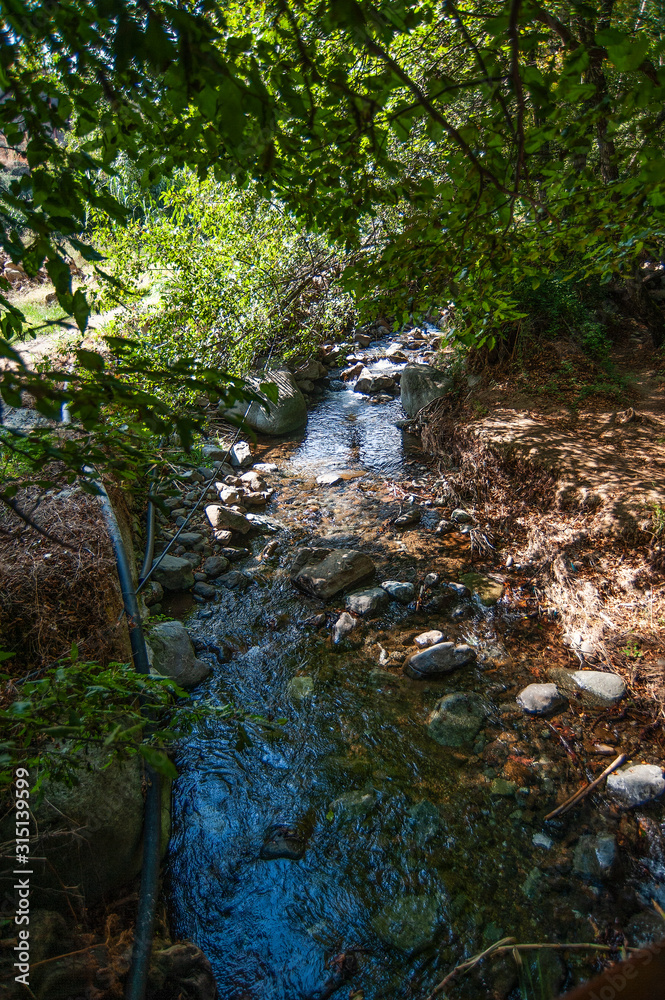Obraz premium Kakopetria is one of the few villages in the world that can boast of its own park with a stormy river, shady banks and elegant bridges. 