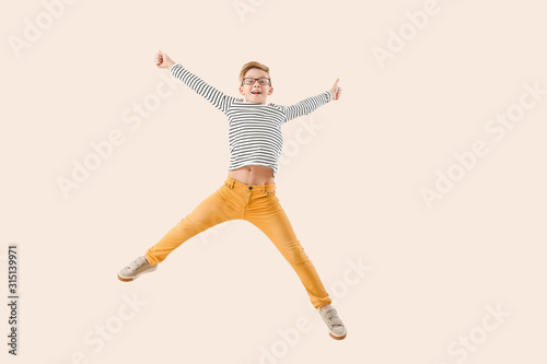 Jumping little boy showing ...