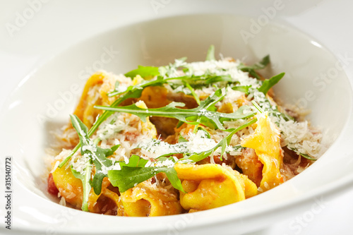 Tortellini with Perch and Tomato Sauce in Restaurant Isolated