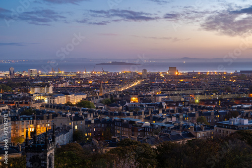 Beautiful landscape of Edinburgh / Scotland panoramic view of Edinburgh from the Calton Hill with the New Old Town on golden light twilight