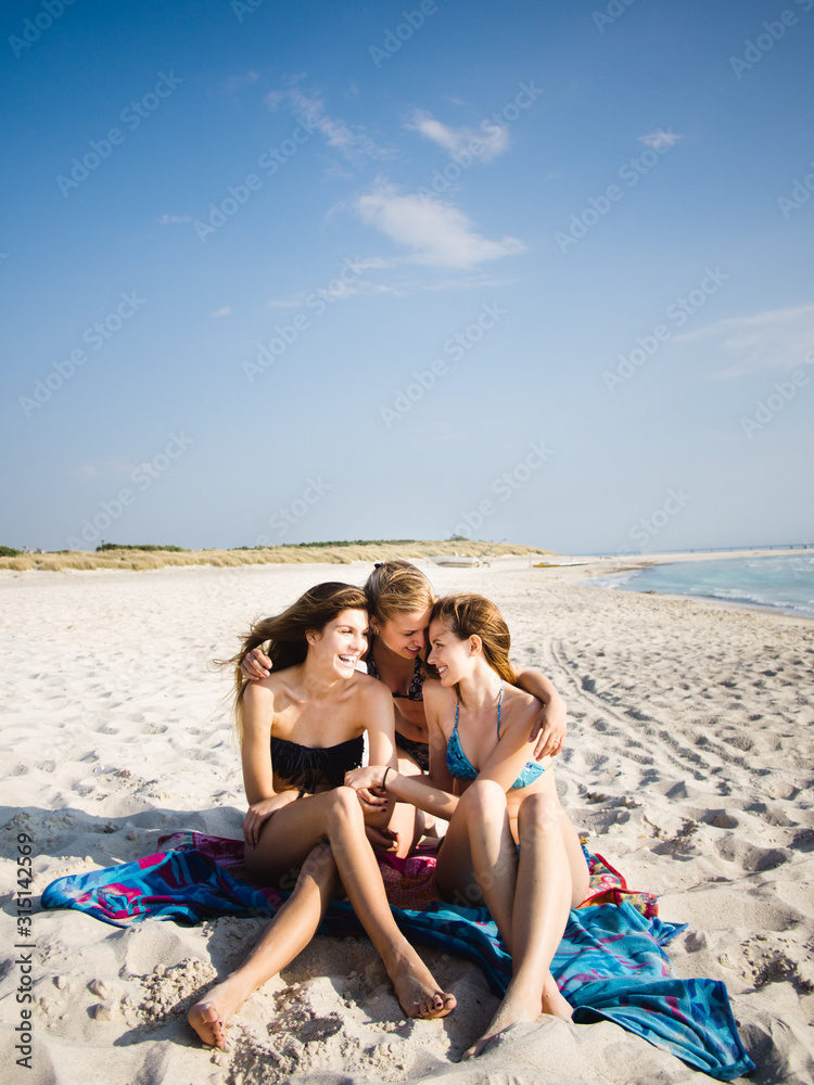 Three girls having fun on the beach