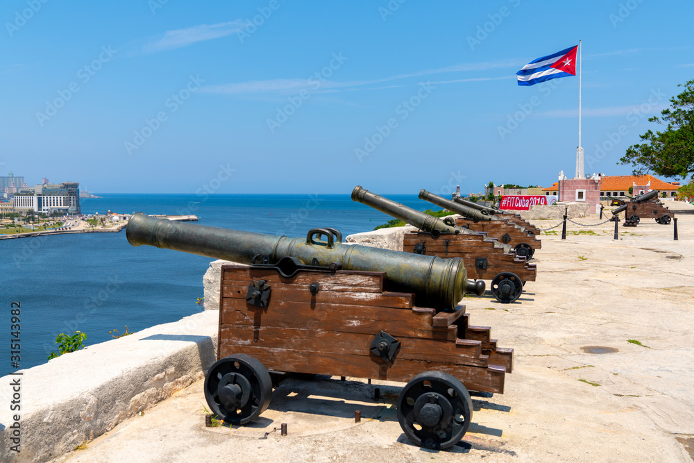 Cannons at Fort of Saint Charles, cuban flag in Havana Cannons at Fort of Saint Charles, cuban flag in Havana