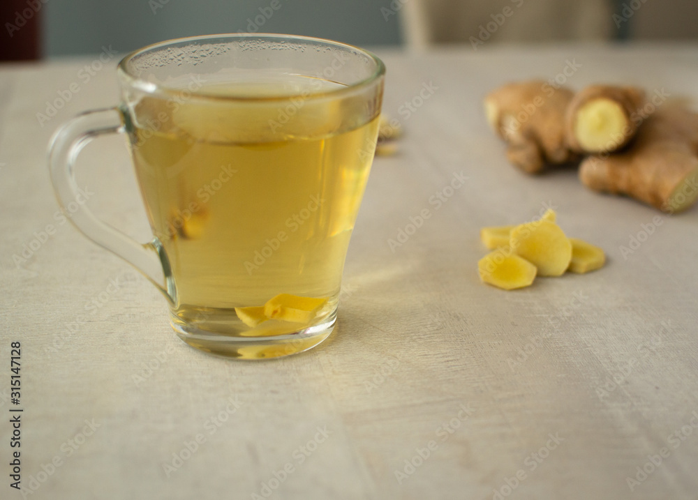 Fresh ginger tea on a light background. Ginger is suitable for cooking and preparing drinks. Close-up