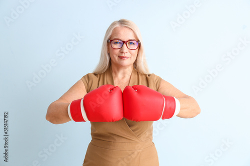 Woman in boxing gloves on c...