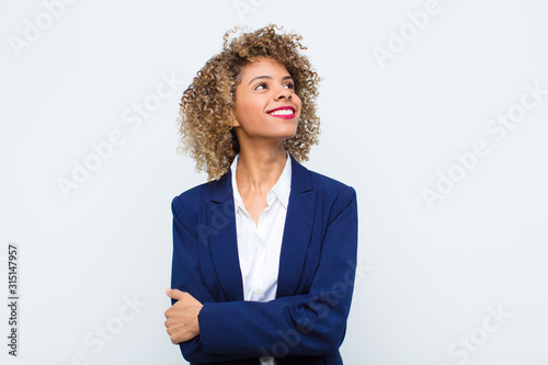 Принти на полотні young woman african american feeling happy, proud and hopeful, wondering or thin