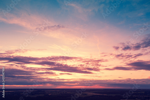 Aerial view of countryside in evening at sunset light. Beautiful nature landscape with cloudy sky