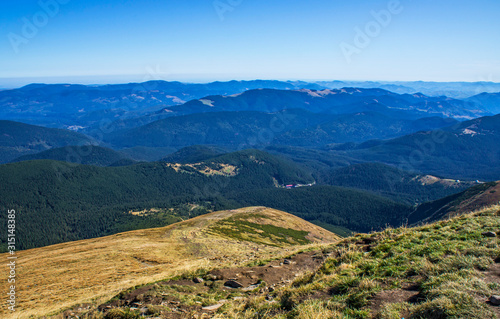 Colorful mountain landscape in the summer mountains. Large hills with blue sky.