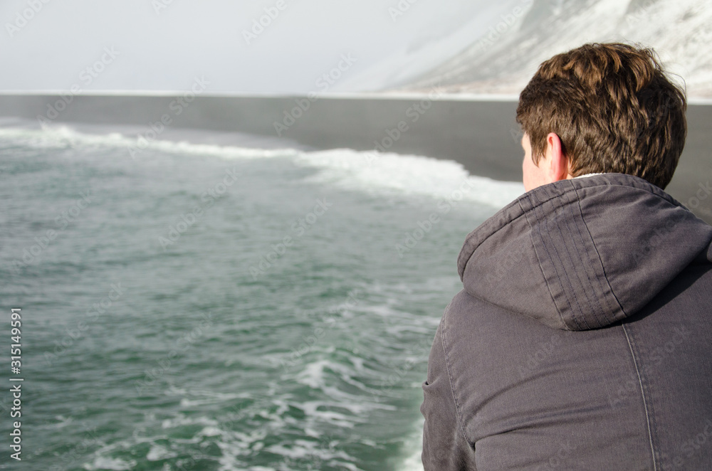 Man starring at the sea in Iceland February 2018
