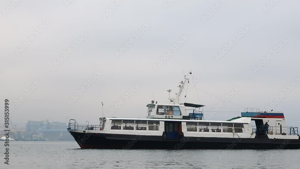 Ferry with passengers sailing in the bay Ferry with passengers sailing in the bay