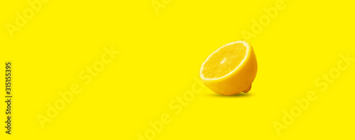 sliced lemon on yellow  background, panoramic image with space for text