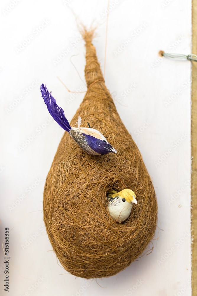 Fototapeta premium Indian traditional handmade bird with its nest and babies is displayed in a street shop for sale. Indian handicraft and art