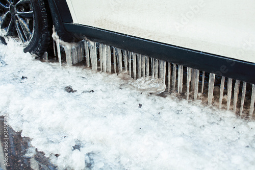 close up photo off car in iciles, a lot of water and snow, seasonal issues concept photo