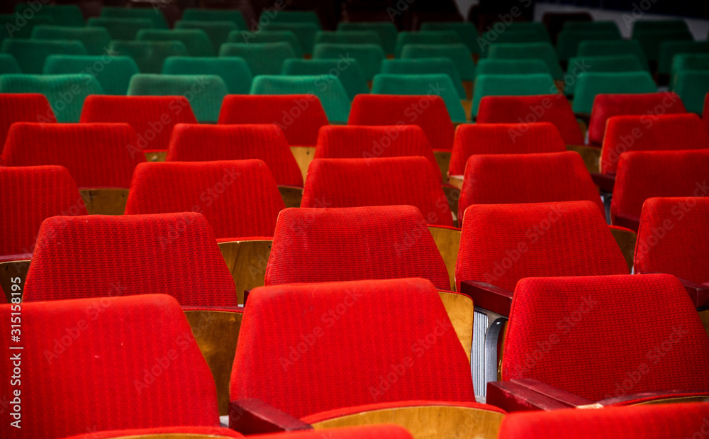 Abstract image with rows of red and green chairs