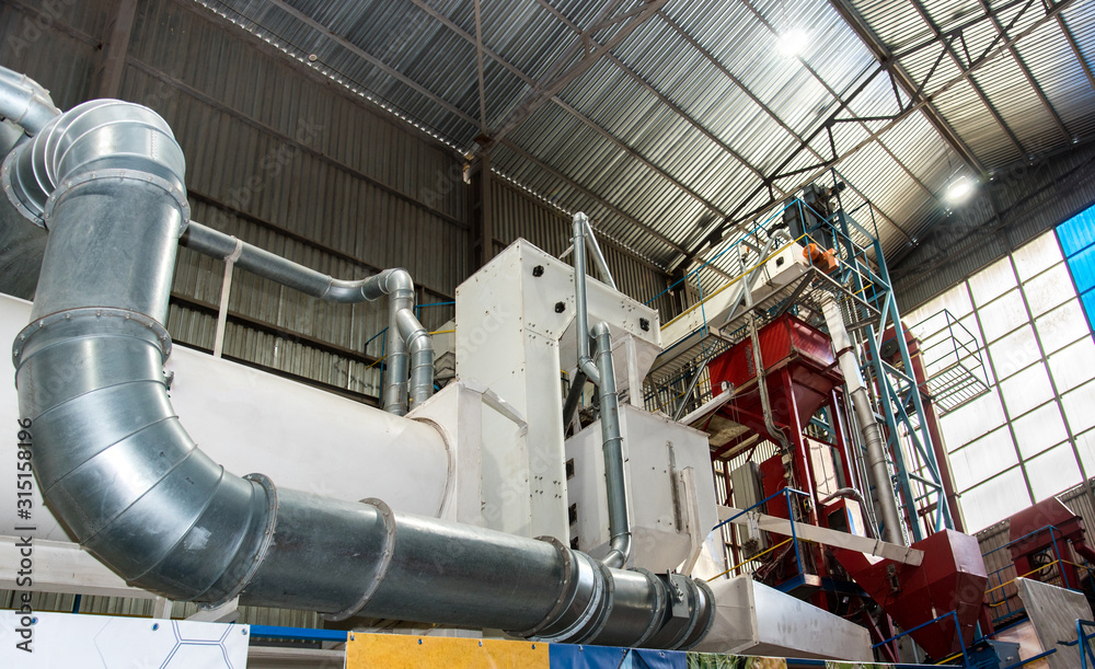 Trybuhivtsi, Ukraine – June 15, 2018: Agroindustrial view with internal structures and equipment of grain elevator in Ternopil region.