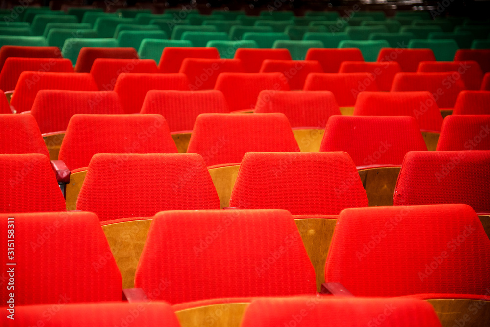 Abstract image with rows of red and green chairs