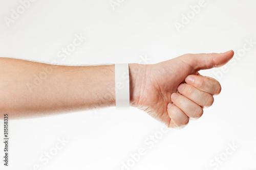 Hand with white wristband mockup. Empty ticket wrist band design. © Andrii Zastrozhnov