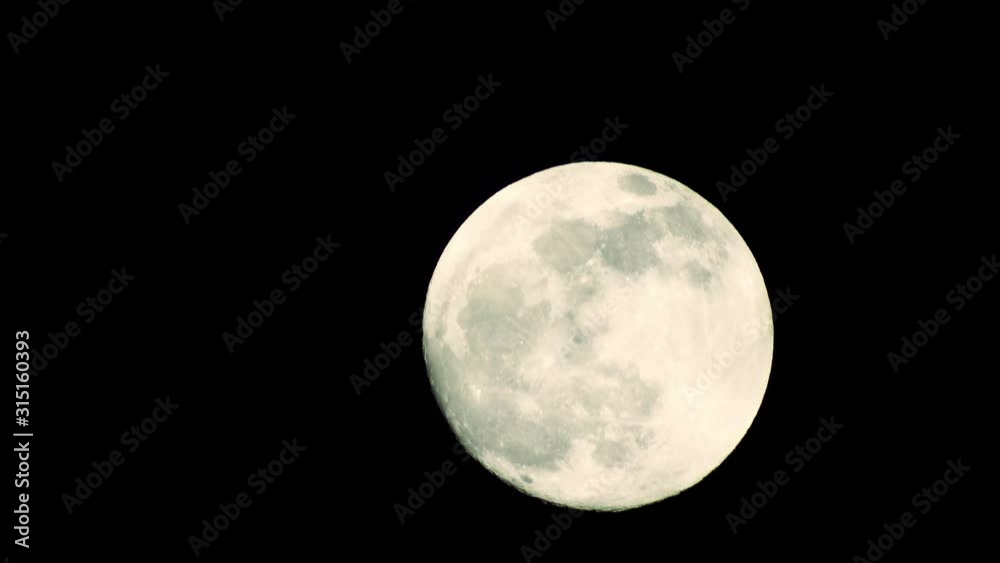 Clouds passing by moon at night. Full moon at night with clouds in real time. Clouds passing by moon at night. Full moon at night with clouds in real time.
