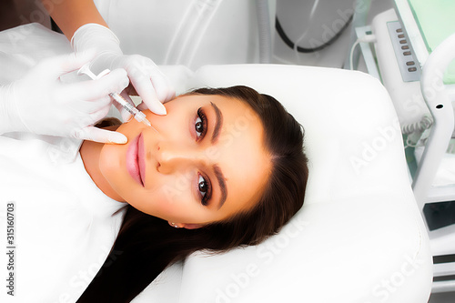 A beautiful woman lies on a skin rejuvenation procedure.