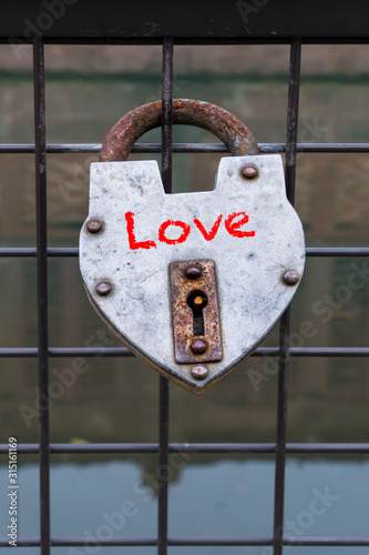 hanged love padlock on a fence of bridge for valentines day