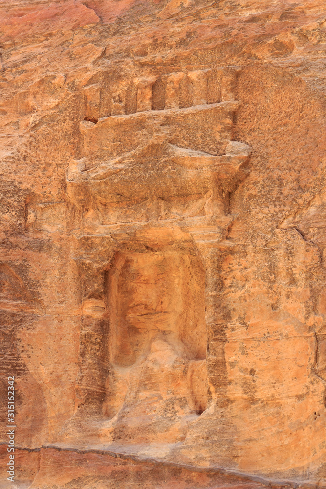 Niche containing sacred stone Baetyl at gorge canyon Siq in ancient city of Petra in Jordan