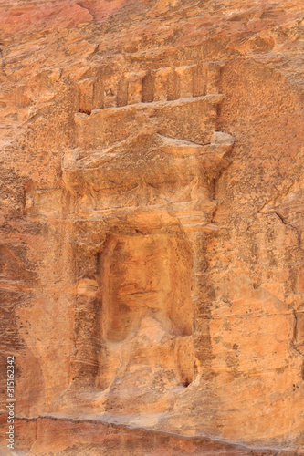 Niche containing sacred stone Baetyl at gorge canyon Siq in ancient city of Petra in Jordan