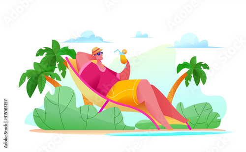 Joyful tourist man is lying on beach by sea