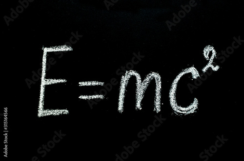 Einstein's formula drawn on chalkboard
